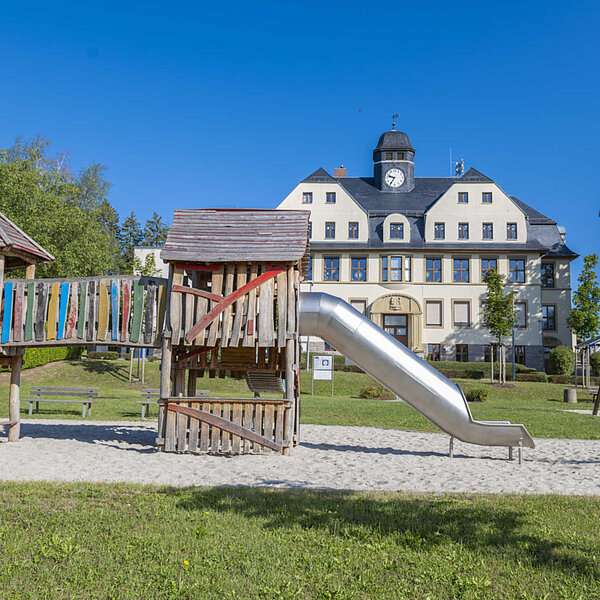 Spielplatz Köthensdorf, großes Klettergerüst mit Grundschule Schloss Köthensdorf im Hintergrund